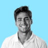 Young man smiling on a blue background